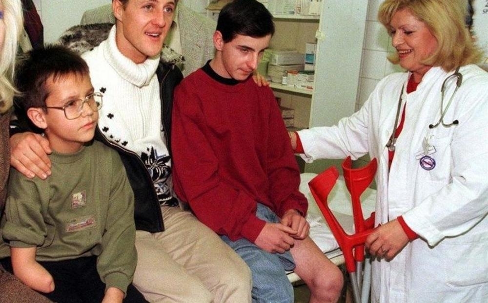 Michael Schumacher with injured children